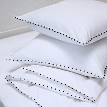 minimal bed linen with handmade buttons embroidery