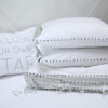 AYA bed linen with buttons embroidery