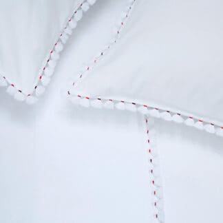 Embroidered bed linen with white pompoms and colored thread, ILAN