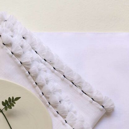 embroidered table linen with pompoms 3