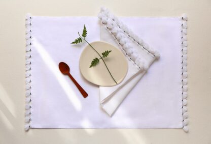 embroidered table linen with pompoms 2