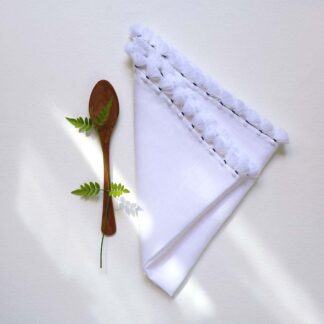 ilan white embroidered table linen with pompoms