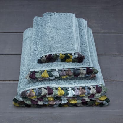 water color bath linen with colored pompoms folded