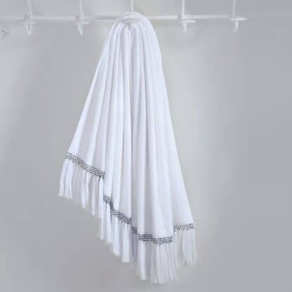 Luxury white bath towels with hand-embroidered pompoms
