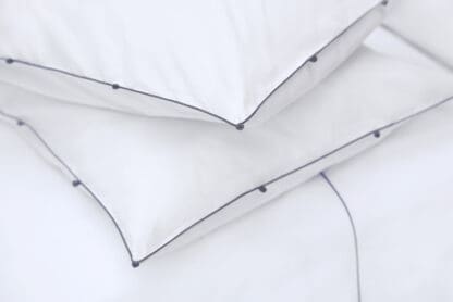 hand-embroidered bed linen with trimmings white and grey