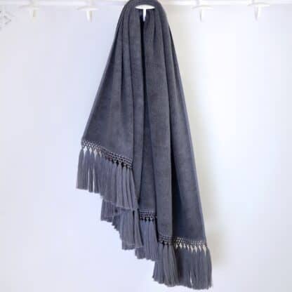 grey bath towel with grey pompoms