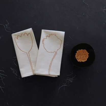 Pair off hand embroidered napkins on ecru cotton